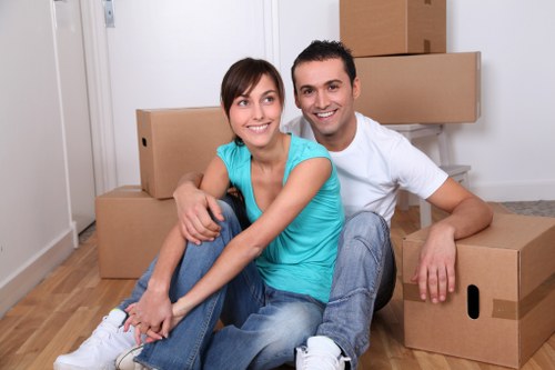 Moving team carrying packed boxes for a flat relocation